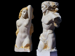 A photograph of two classical marble sculptures of a man and woman.